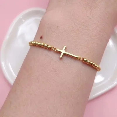 Pulsera cruz ajustable